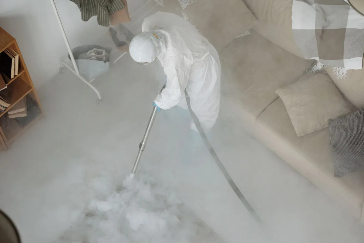 Biohazard cleanup technician in protective equipment, Paragould, AR